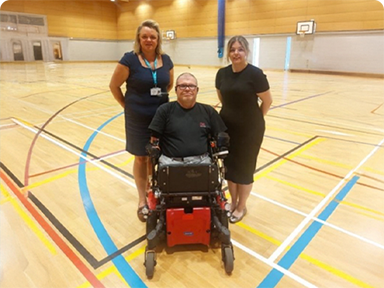 Photo of Ross Care colleagues Sarah Atkins and Emily Galton with Peter Hull MBE