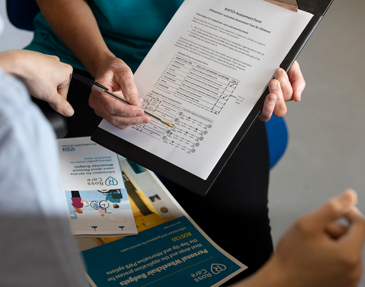 Photograph of a clinician and service user going through a WATCh Assessment Form