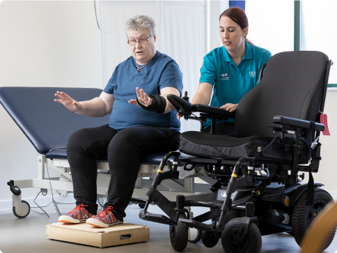 Photo of a service user in clinic with a wheelchair service clinician